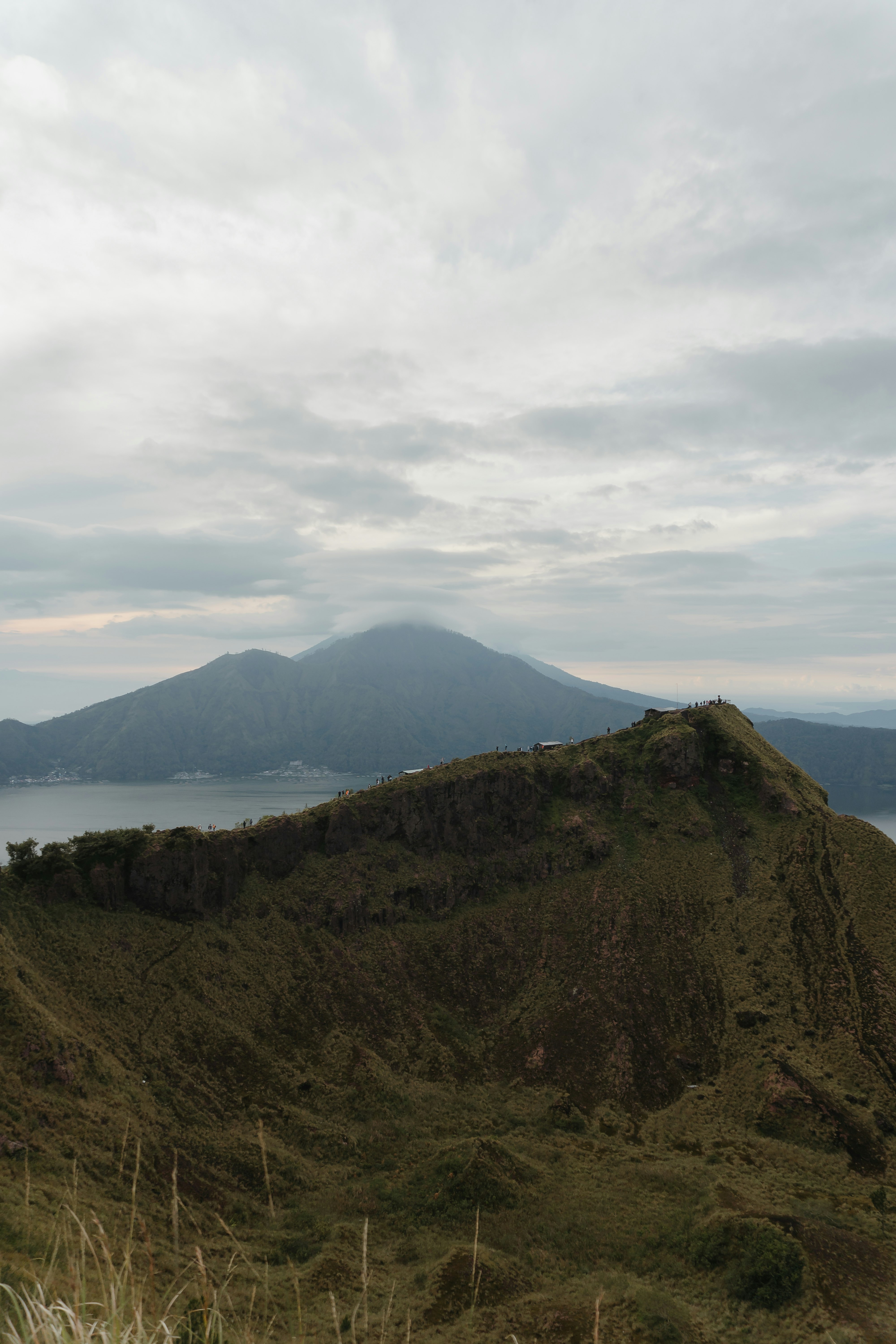 green mountain near body of water during daytime